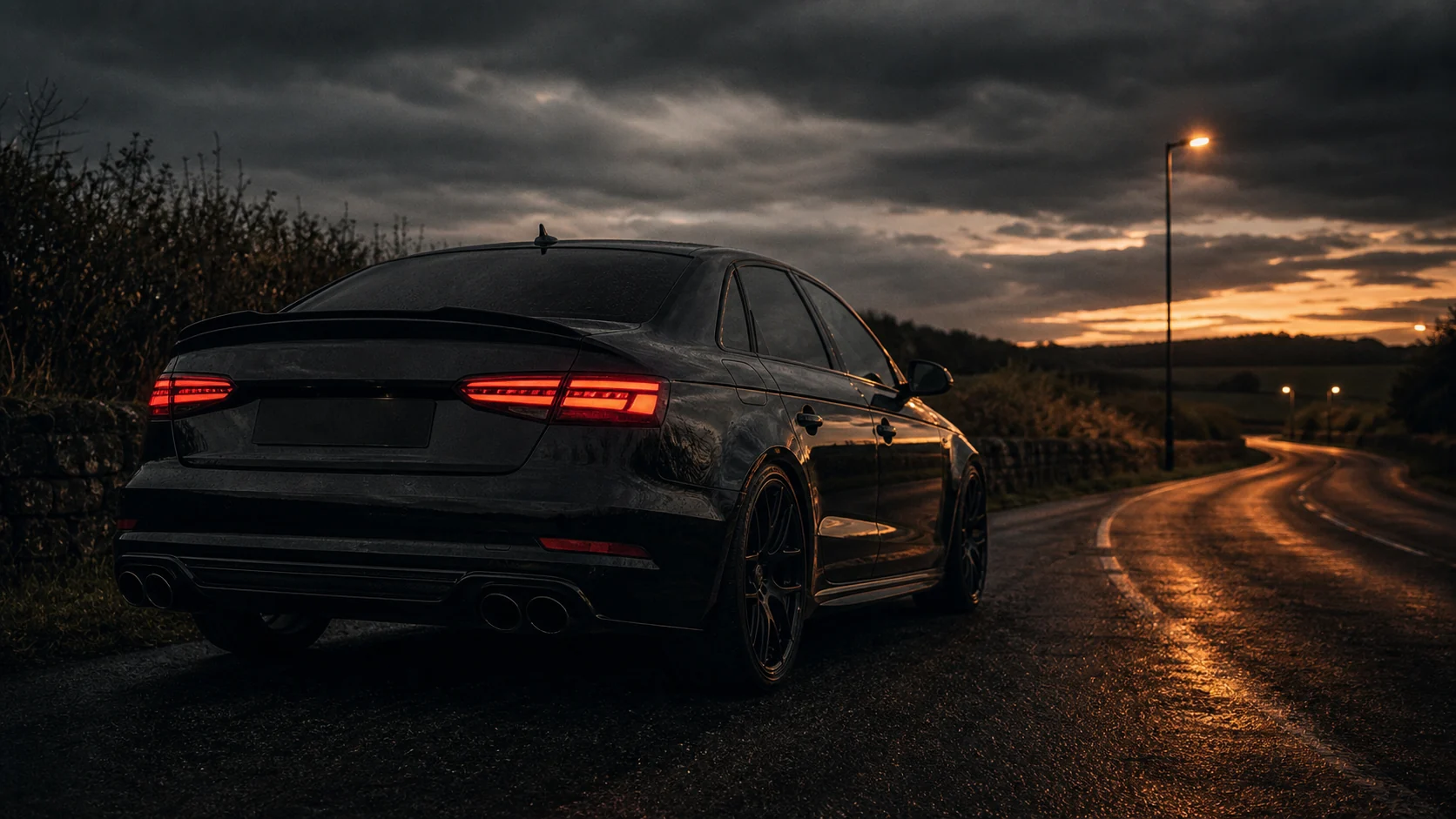 Dark performance car on a UK road at dusk illustrating the best first car mods for real-world speed, grip and reliability